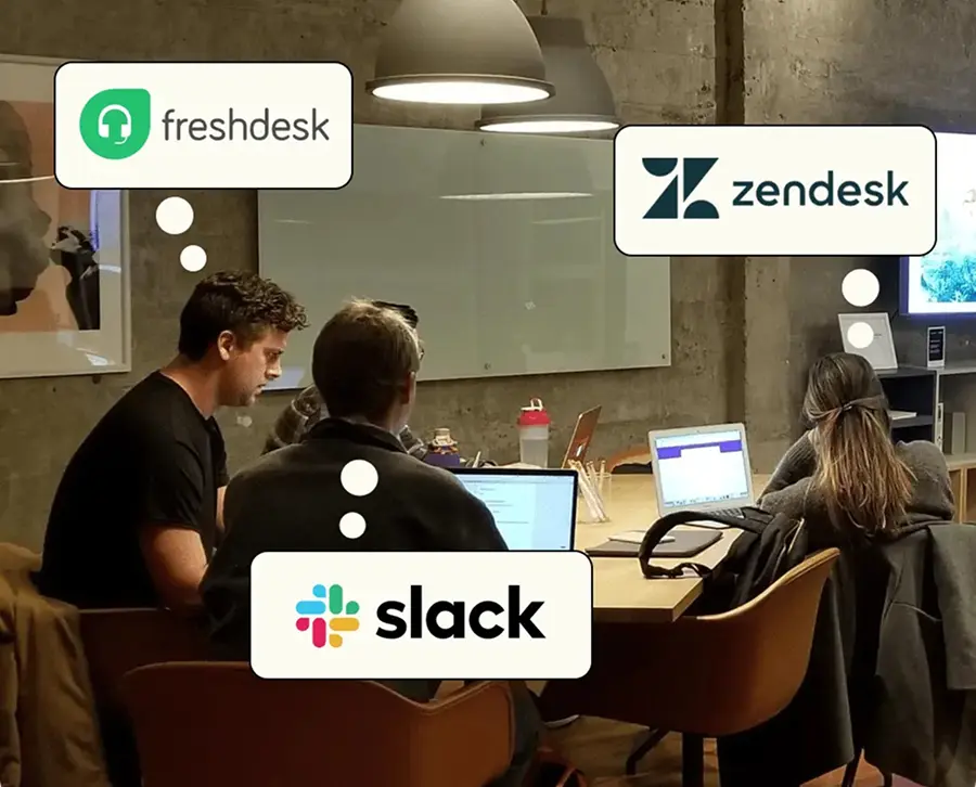A photo showing four people on their laptops, responding to customer reviews