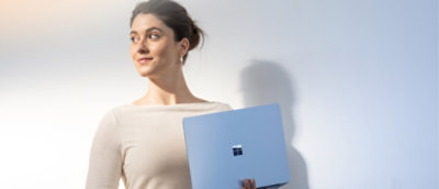 Eine Frau, die mit einem Laptop steht