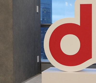  Large red lowercase 'd' near window with city view.