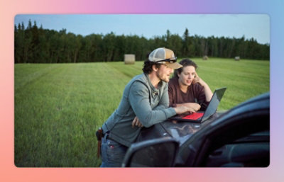 A man and woman looking at a laptop