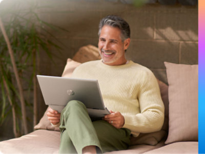 Person sitting on a sofa using a laptop 