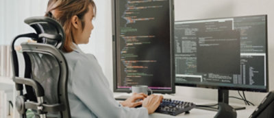 Women working on a computer in an office environment.
