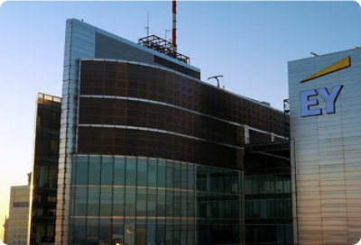 A low angle view of a building with the text EY on it.