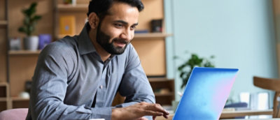 Man sitting at desk working on laptop