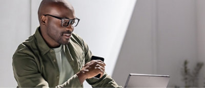 A man working on the laptop and smiling