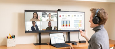 A person talking to a group of people on a video call.