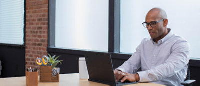 A man sitting in front of a laptop computer