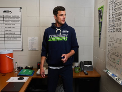 Person wearing a navy blue Seattle Seahawks hoodie