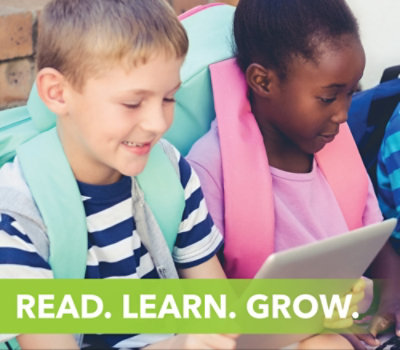 Dua anak dengan ransel duduk berdampingan sambil menggunakan tablet. Kata-kata "READ. LEARN. GROW." ditampilkan di bagian bawah.