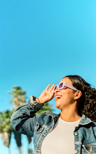 A person smiling, feeling relaxed and confident about their money and personal finances.
