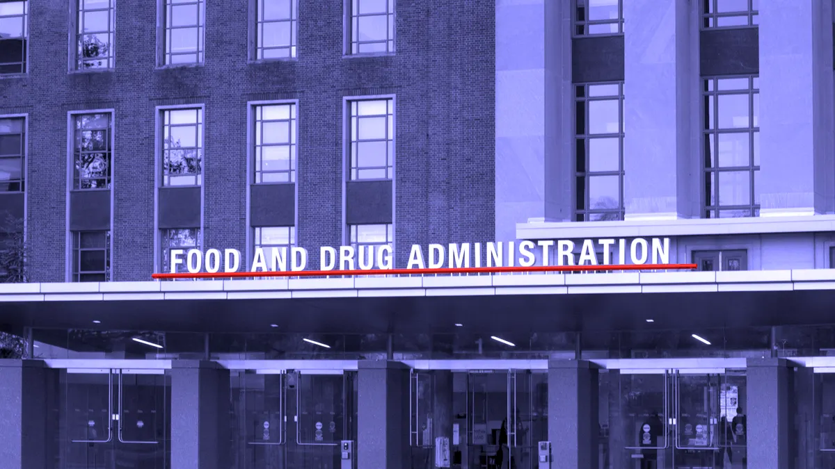 A sign reading Food and Drug Administration hangs over a building entrance.