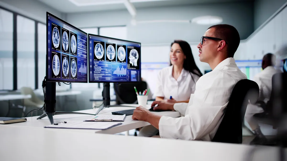 Doctors In Clinic Looking At Brain MRI Scan