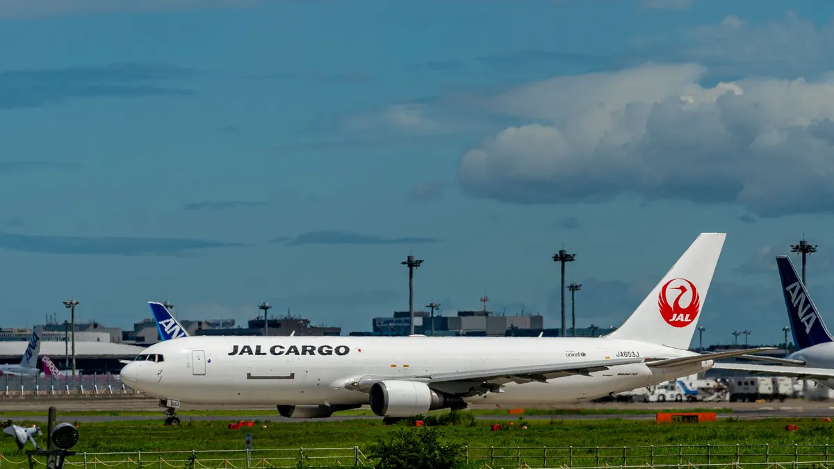 A Jal Cargo plane is about to take off from a runway