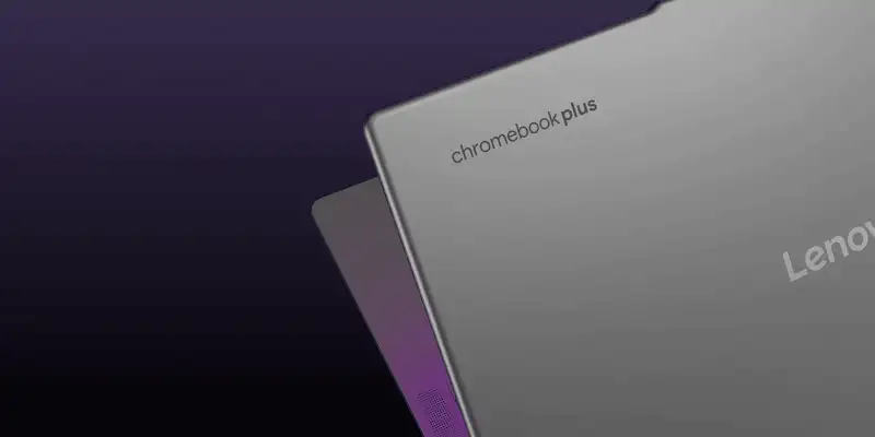 A silver Chromebook Plus laptop by Lenovo is shown at an angle against a dark purple background.