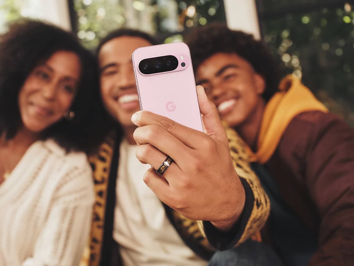 A group of three friends taking a selfie on a Rose Quartz Google Pixel 9 Pro.