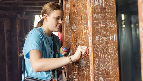 a future SEMO student signs her name in the dome during camp redhawk a summer camp in cape girardeau mo