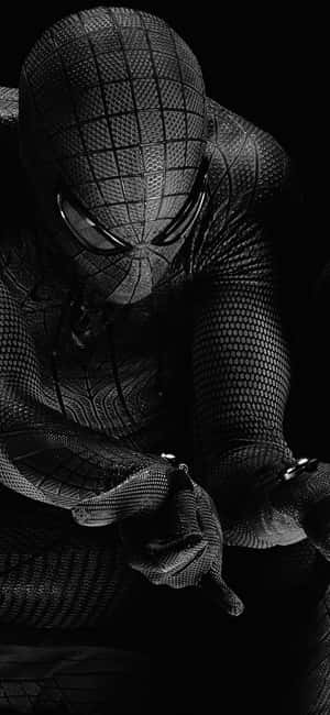 Spider-Man in a textured suit crouching in darkness. — iPhone Wallpaper