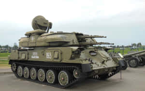 Olive green military tank with multiple barrels and radar dish on display. — War Wallpaper