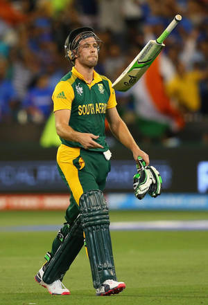 South African cricket player walking off field with bat and gloves at night. — Challengers Wallpaper