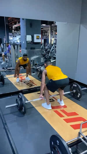 Man lifting barbell in gym with mirror reflection — Gym Wallpaper