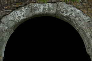 Weathered stone archway with moss and dark interior — Castle Wallpaper