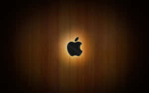 Zwart Apple-logo verlicht op een houten oppervlak met zachte verlichting. — Apple Mac Desktop Achtergronden