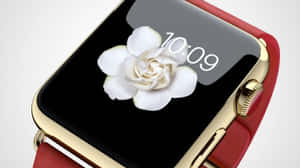 Guld smartur med rød rem, der viser en hvid blomst og tiden 10:09. — Apple Watch Wallpapers