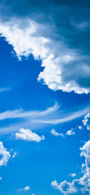 Vibrant blue sky with fluffy white clouds and wispy streaks — iPhone Xr Wallpaper