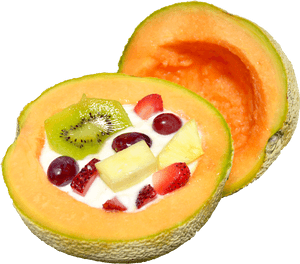 Cantaloupe half filled with yogurt and mixed fruit pieces. — Fruit Wallpaper