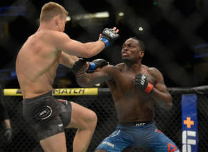 Two MMA fighters in an octagon during a high kick exchange. — Fight Wallpaper