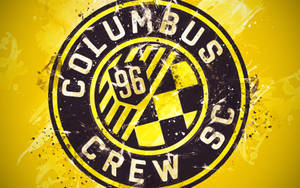 Columbus Crew SC fodboldholdlogo med gul og sort splatterdesign. — Design Wallpapers