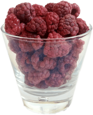 A glass filled with fresh red raspberries. — Fruit Wallpaper