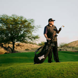 Golfer holding club on green course with tree and bag — iPad Air 11 Wallpaper