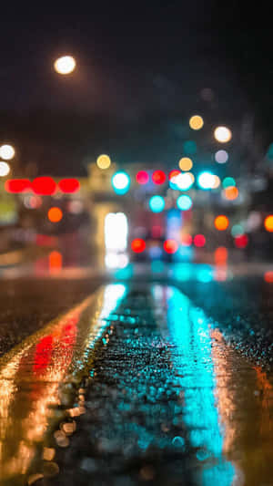 Rainy night street with glowing traffic lights reflected in wet pavement. — iPhone 7 Plus Wallpaper