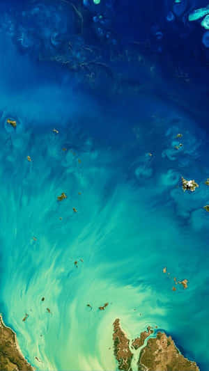 Aerial view of swirling blue and turquoise ocean waters around scattered landmasses. — iPhone 7 Plus Wallpaper