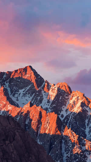 Snowy mountain peaks bathed in pink sunset light. — iPhone 8 Plus Wallpaper