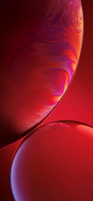 Two glossy red spheres with swirling purple patterns float in a gradient background. — iPhone Xr Wallpaper
