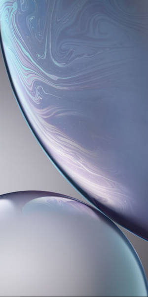 Two floating glass orbs with swirling iridescent patterns. — iPhone Xs Wallpaper