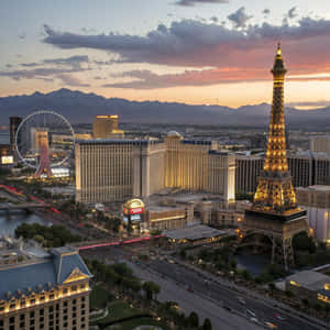 Las Vegas skyline at dusk with Eiffel Tower replica and High Roller Ferris wheel lit up. — Travel Wallpaper