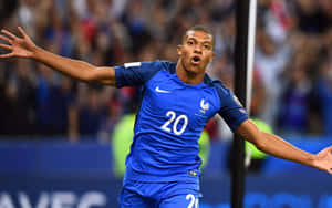 Soccer player in blue jersey celebrating victory at night stadium. — Mbappe Wallpaper