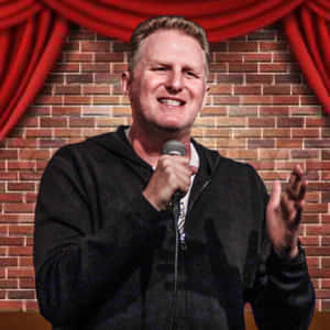 Comedian performing on stage with red curtains and brick wall background. — iPad Air 13 Wallpaper