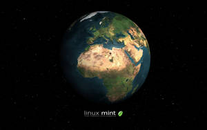 Planète Terre vue de l'espace avec l'Afrique, l'Europe et l'Asie visibles sur un fond étoilé. — Linux Mint Fonds d'écran