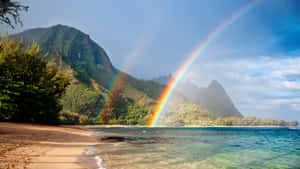 Double rainbow over tropical beach with mountains and clear water — Rainbow Wallpaper