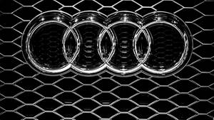 Logotipo de Audi en una parrilla hexagonal negra con acabado cromado — Audi Fondos de pantalla