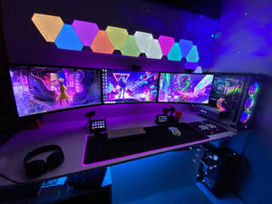 Gaming-Schreibtisch mit mehreren Monitoren, die Cyberpunk-Spiele unter bunten LED-Leuchten zeigen. — Desktop computer Wallpaper