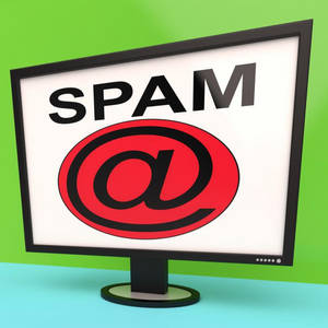 Datorskärm som visar SPAM och at-symbol på skärmen mot en grön vägg och blått golv — E-postadress Bakgrundsbilder