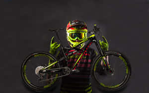 Biker in neon gear holding a mountain bike against a dark background. — Yellow Wallpaper