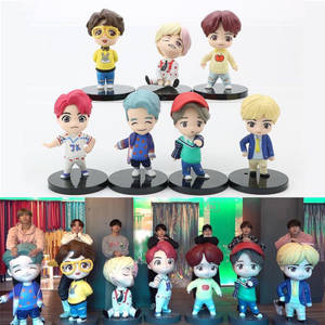 BTS chibi figurines with real members in background. — Tiny Tan Bts Wallpaper