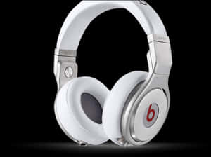 White Beats Pro headphones with silver details and red logo on black background. — Audio Wallpaper