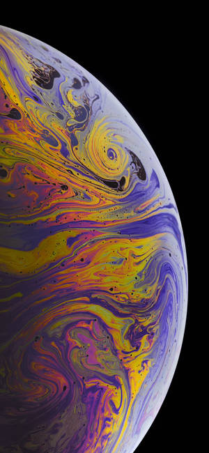 Vibrant swirling nebula patterns on a cosmic sphere against a black background. — iPhone Xs Wallpaper